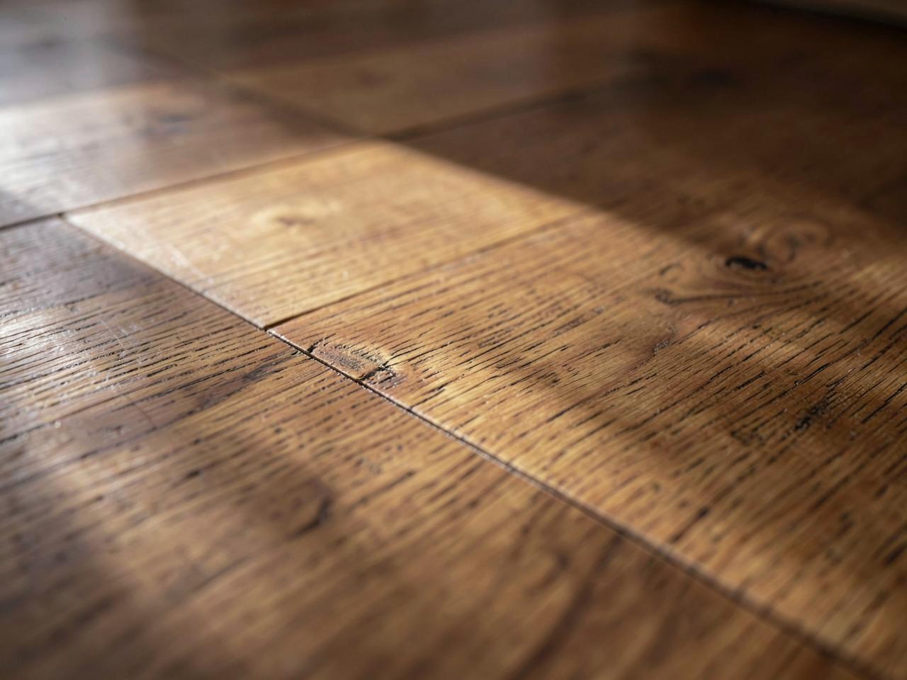 Close-up of solid oak hardwood planks with visible grain in warm natural light